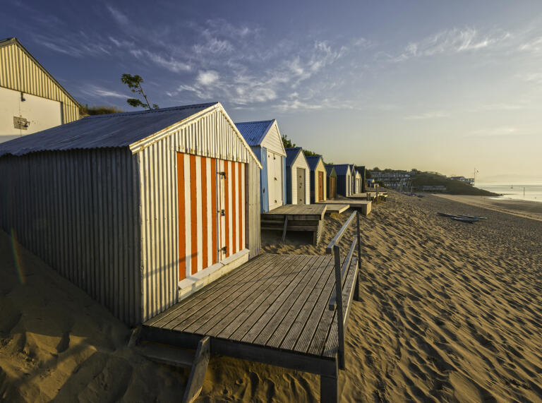 Colourful beach huts by the sea.