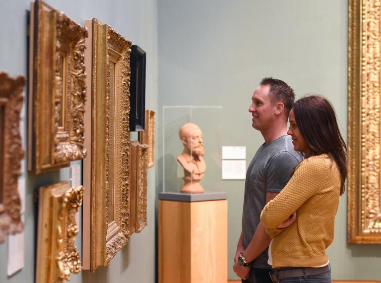 Man and a woman looking at art.
