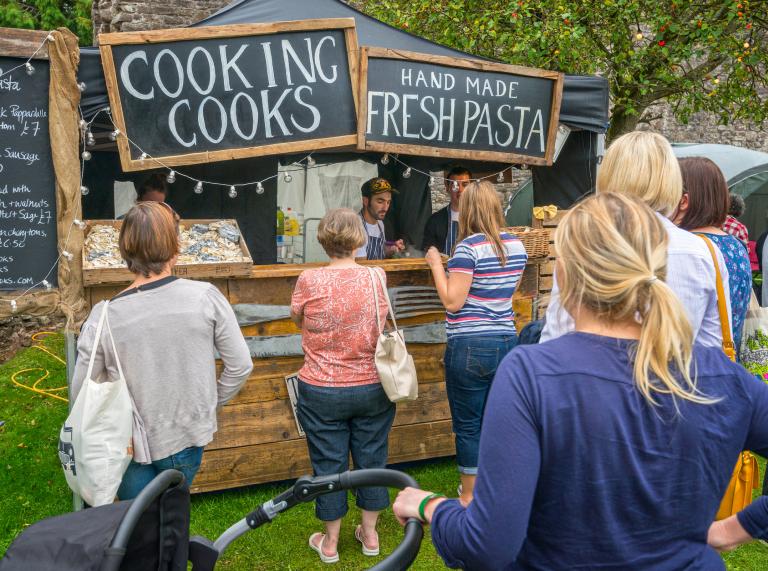 People queuing at a pasta stall at Abergavenny Food Festival