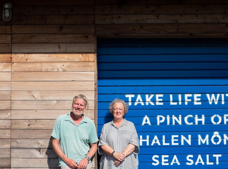 A man and a woman outside the Halen Môn headquarters.