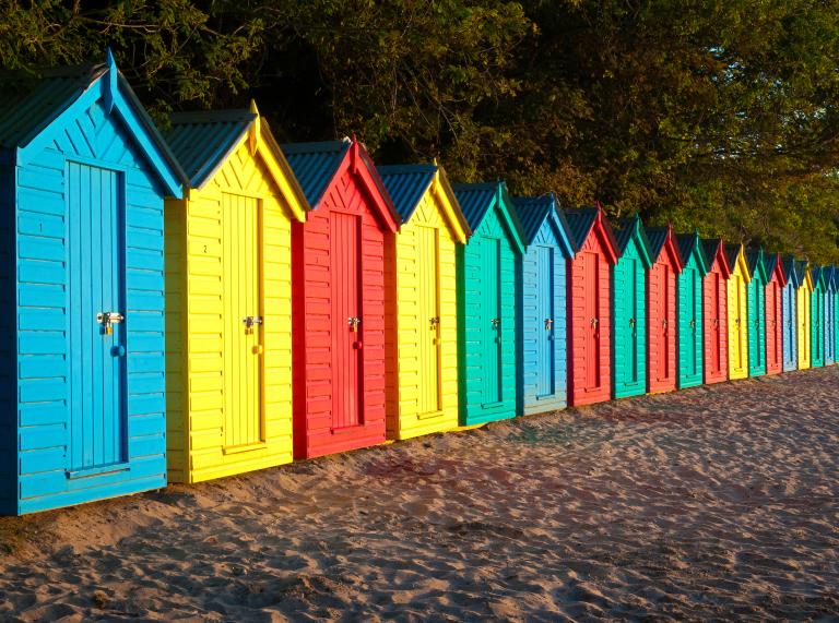 Brightly coloured beach huts.