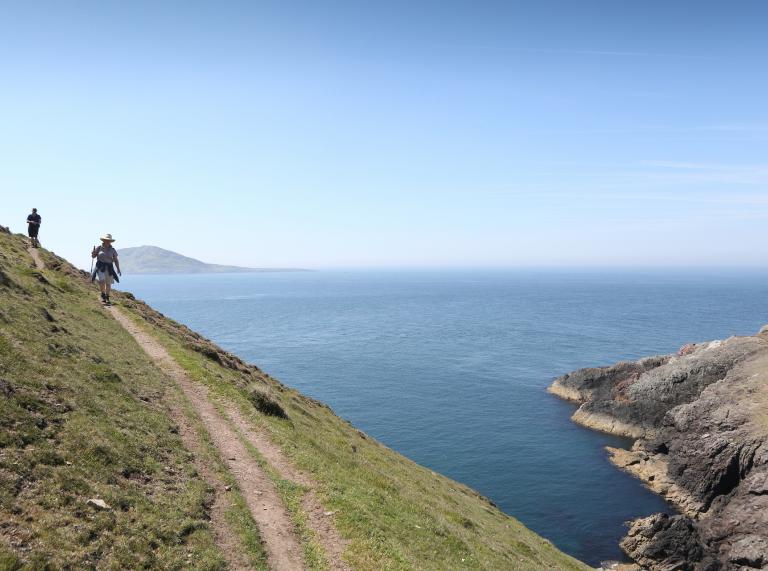 Couple walking on Aberdaron section of the Wales Coast Path