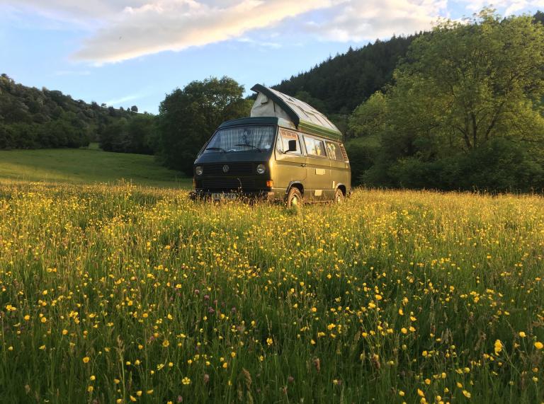 A camper van in a field.