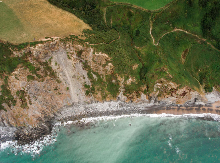 Pathways along the coastline from above.