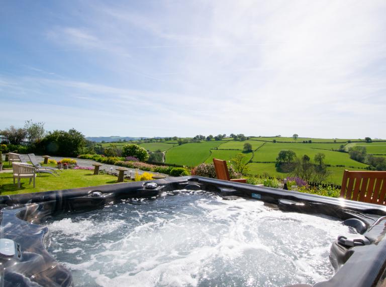 hot tub in foreground with fields beyond