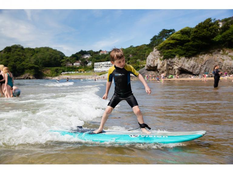 young boy surfing.