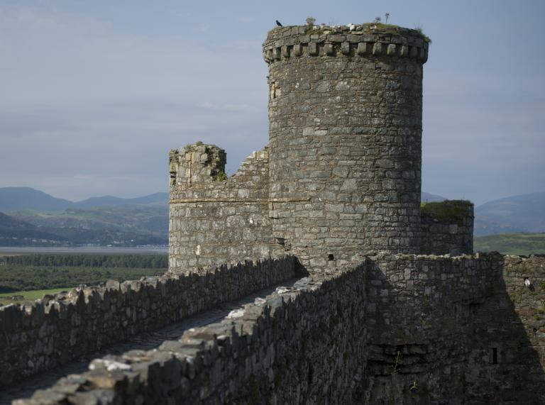 One of Harlech Castle's towers and mountains in the background