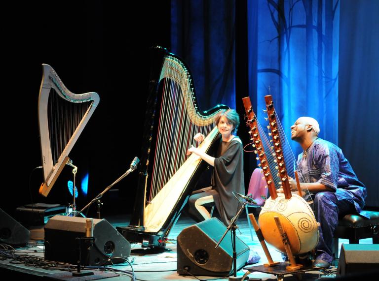 Harpist Catrin Finch and kora (musical instrument) player Seckou Keita on stage .