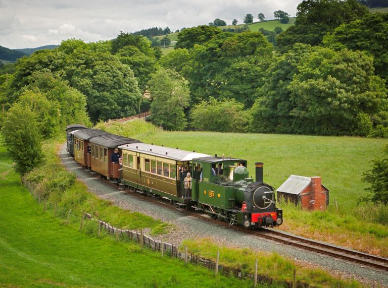 Locomotive passing through countryside on the Welshpool and Llanfair light railway.