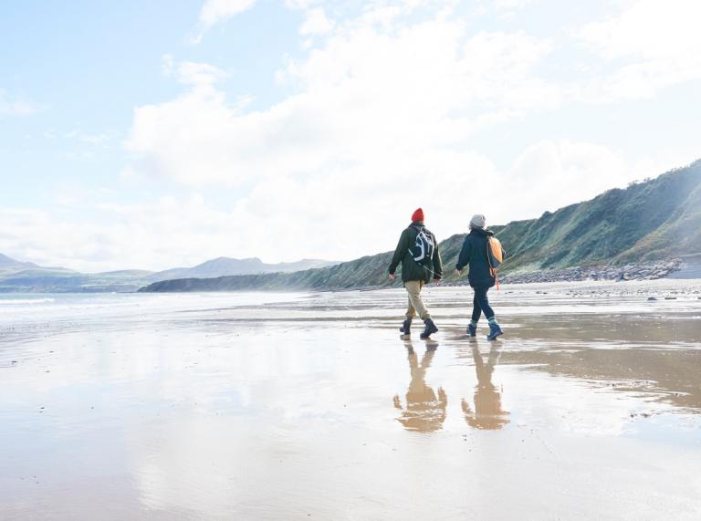 Couple walking Wales Coast Path
