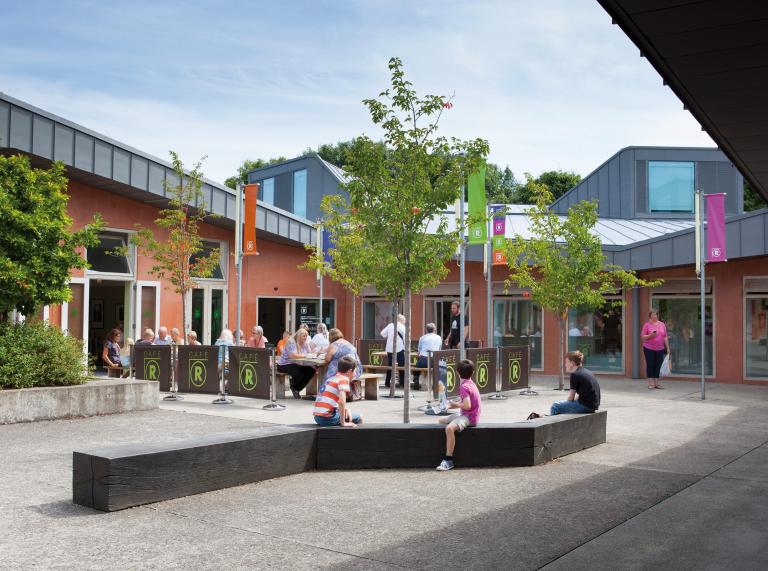 External image of the Craft Centre with people sitting outside in the courtyard