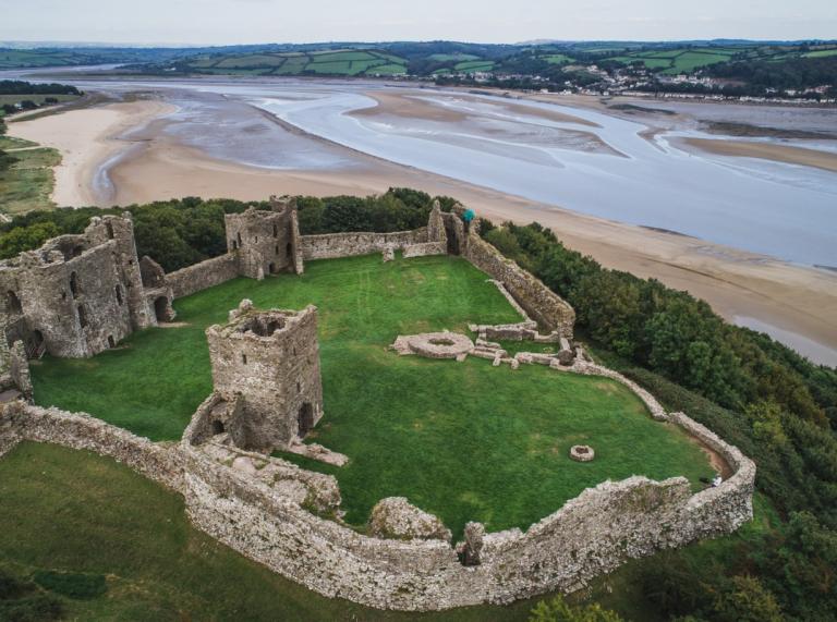 The ruins of Llansteffan Castle in Carmarthenshire from above, with the River Tywi estuary in the background.
