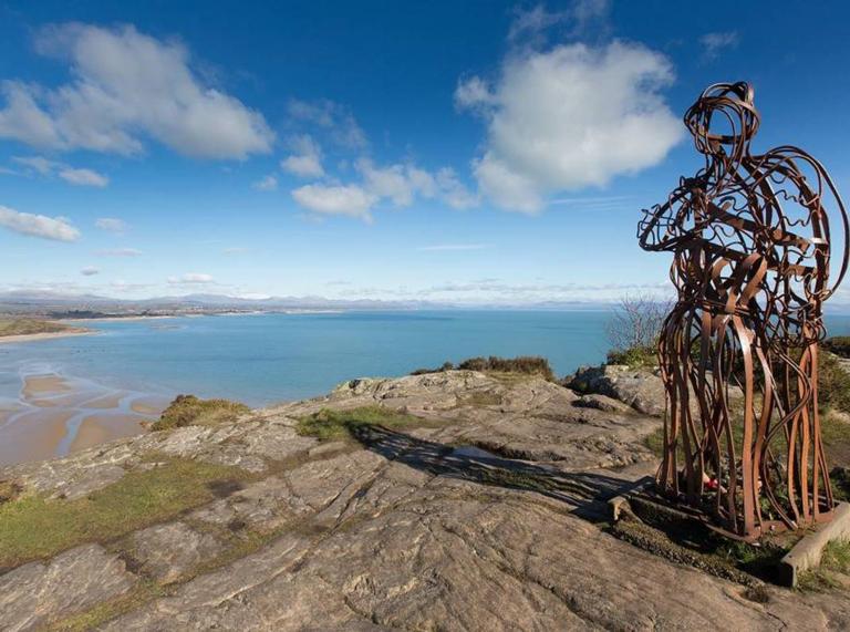 the Iron Man sculpture and sea beyond