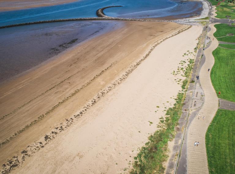 Aerial shot of sea, beach and path