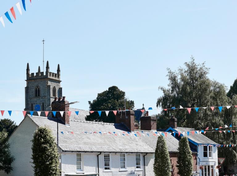 Bunting, church and white building. 