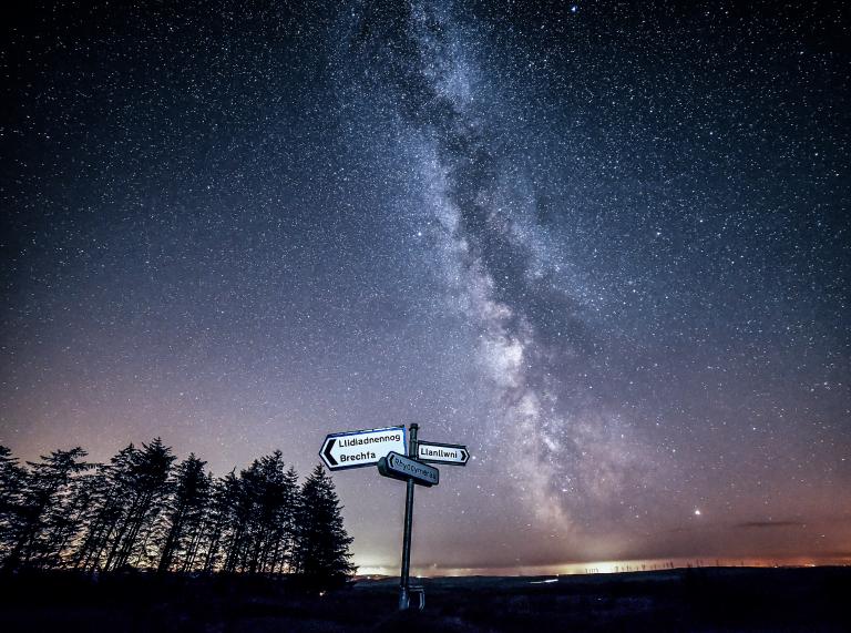 Mid Wales road sign against a backdrop of beautiful stars.