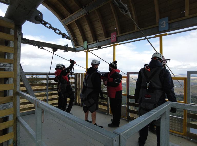 Four people waiting to go down the zip line