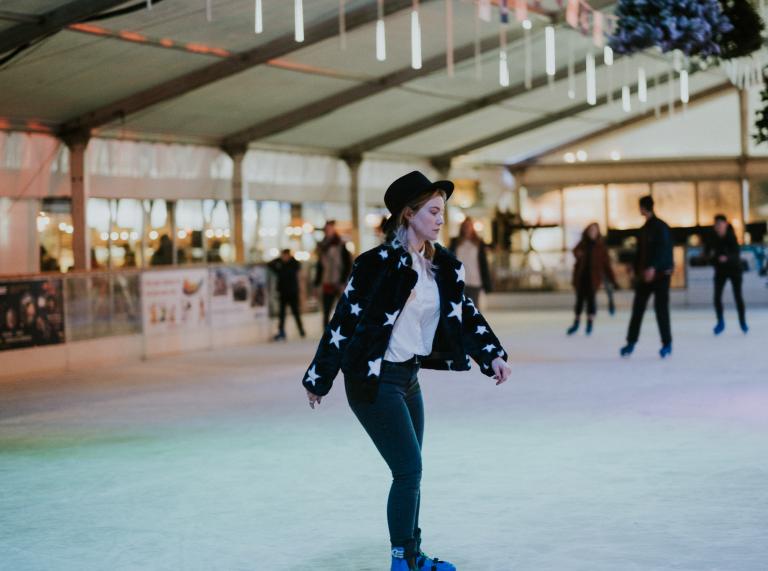 Ice skater with top hat and jacket with stars.