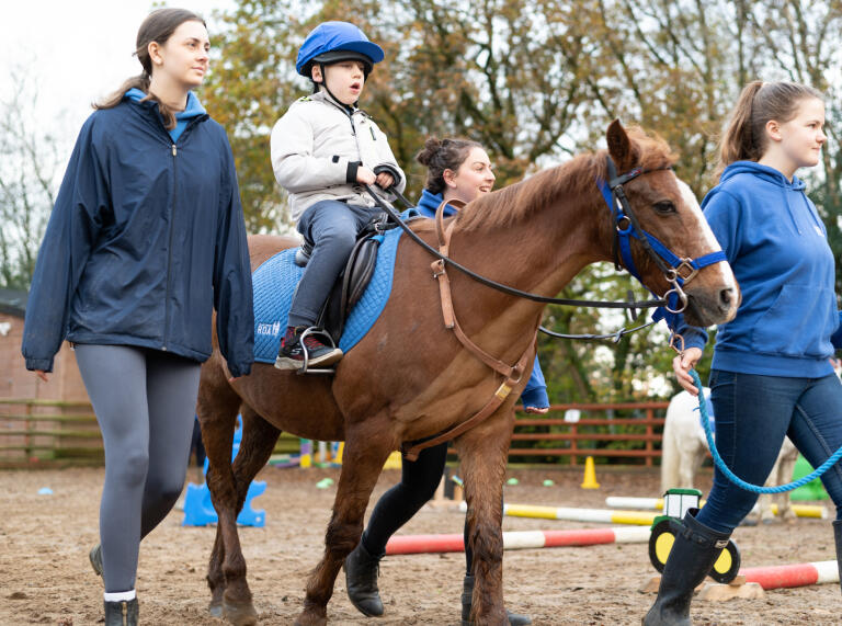 A young person riding a horse.