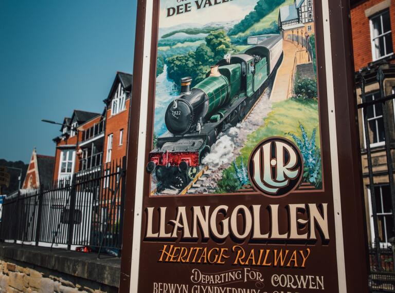 wooden sign with train and words Llangollen Heritage Railway.