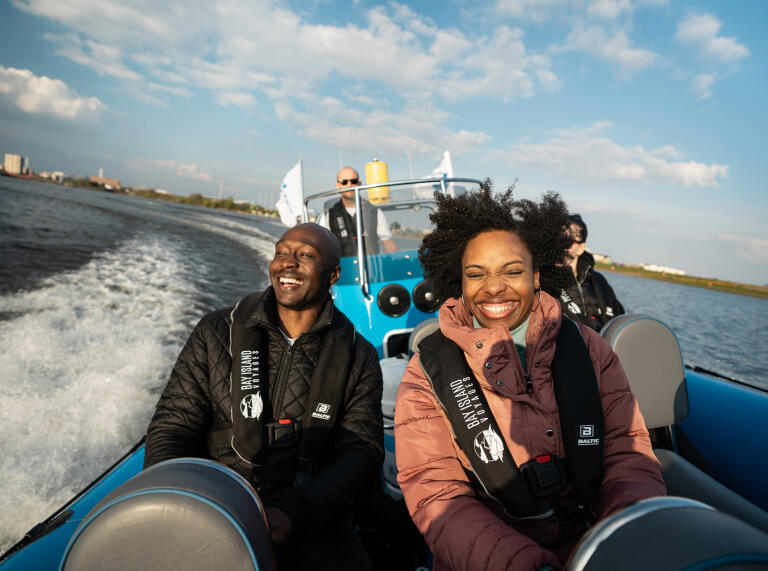 Two people on a speedboat ride.
