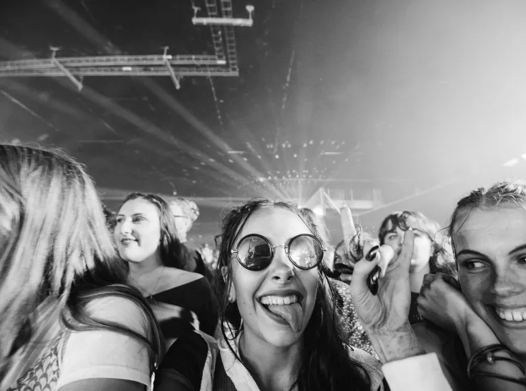 People smiling at a concert