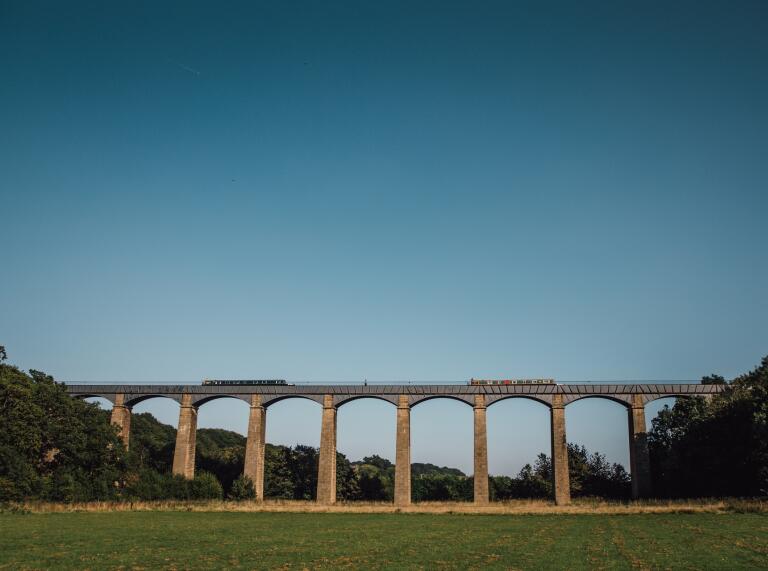 A high canal aqueduct viewed from ground level.