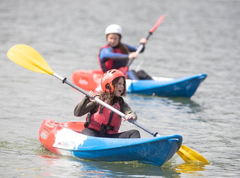 two children kayaking on Llandegfedd  lake.