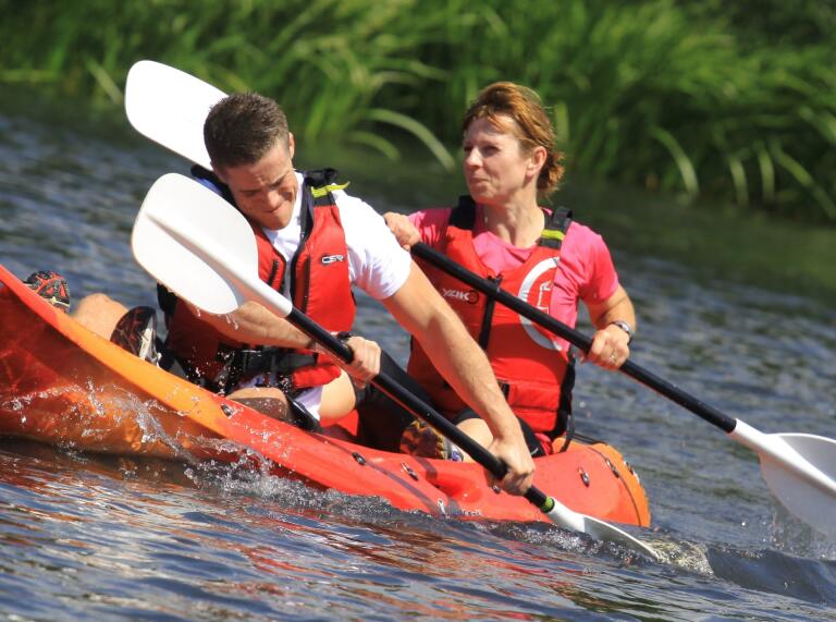 man and woman kayaking.