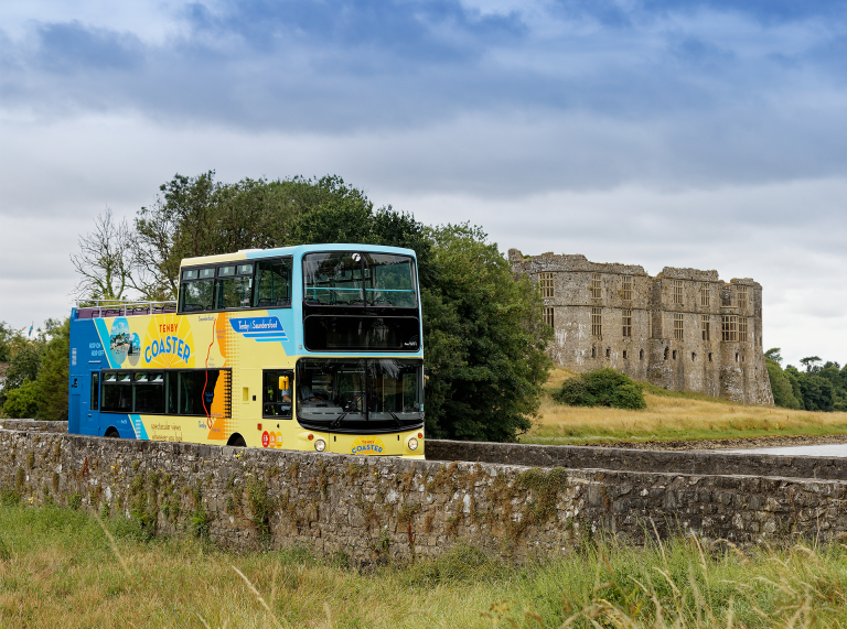 open top bus outside castle.