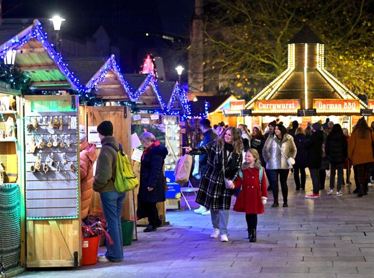 nightshot of Christmas market stalls.