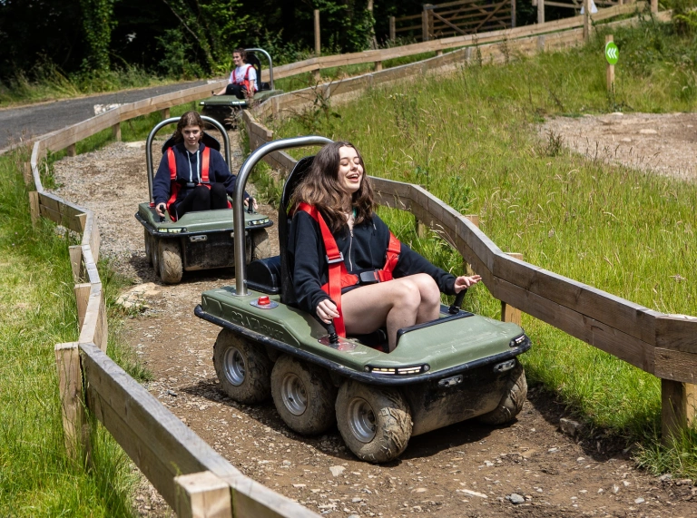 people in small kart vehicles.