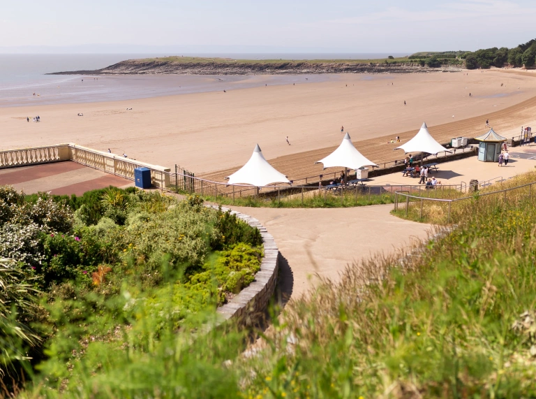 looking down to promenade and sandy beach.