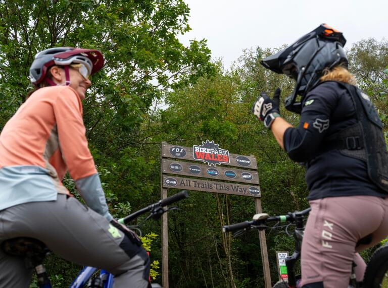 two female cyclists and BikePark Wales sign.