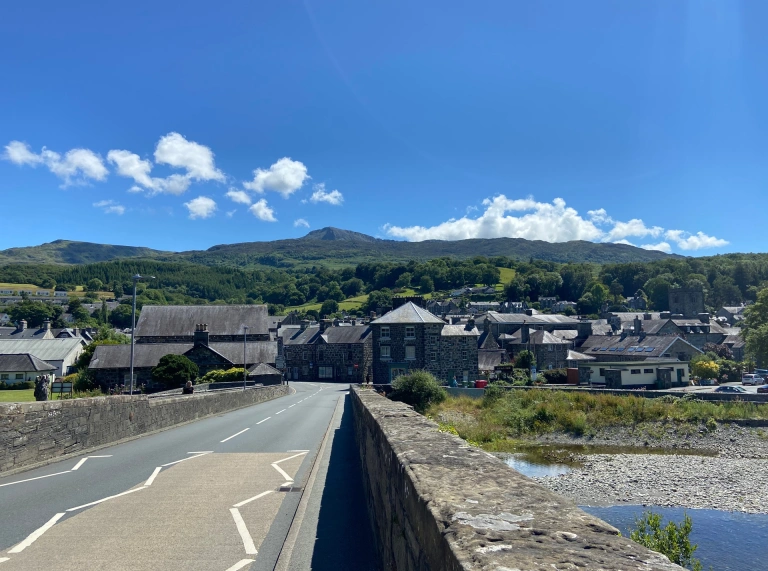 View of a town from a bridge, looking towards mountains. 