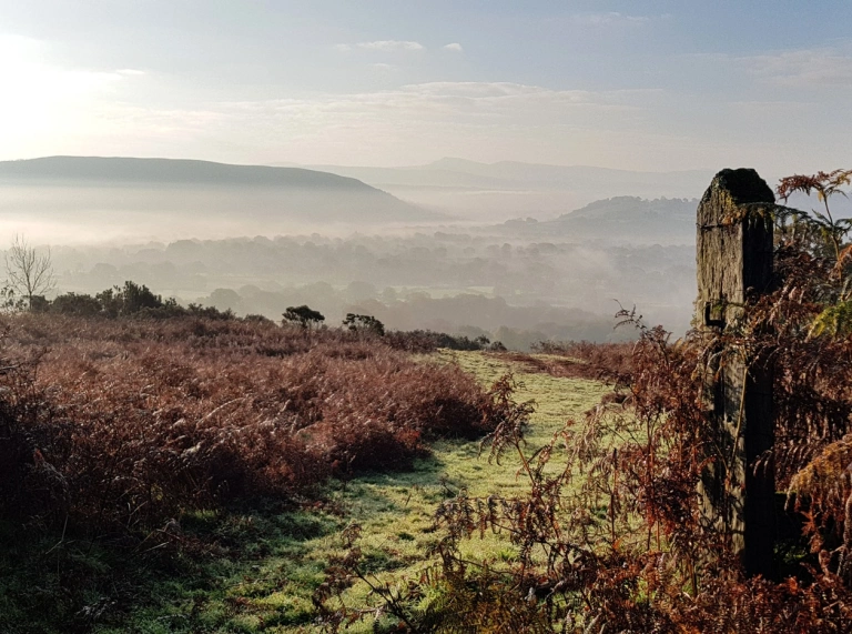 External shot of misty mountains in the distance