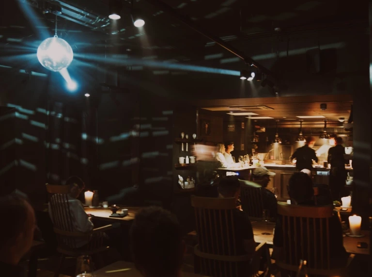 dark interior of restaurant lit by candles.