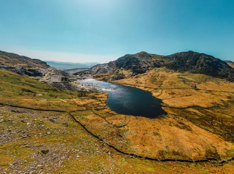 A lake in a quarry, surrounded by mountains