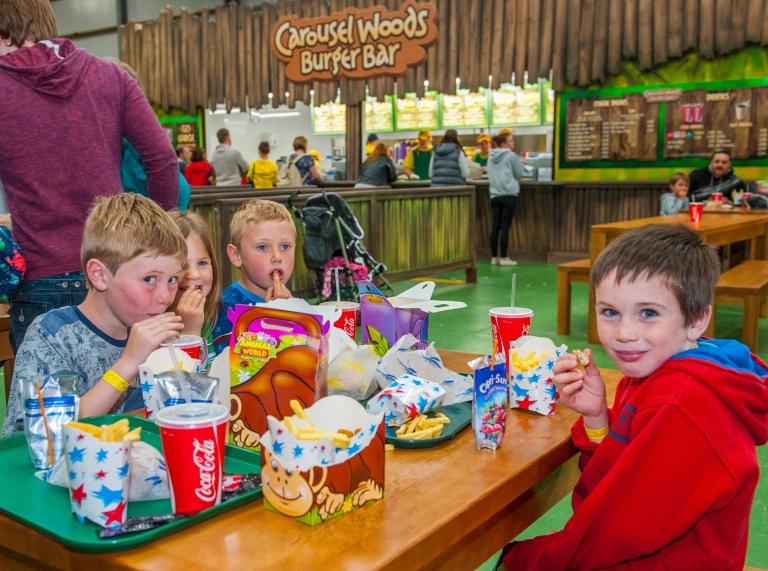 children eating burger meals from boxes.