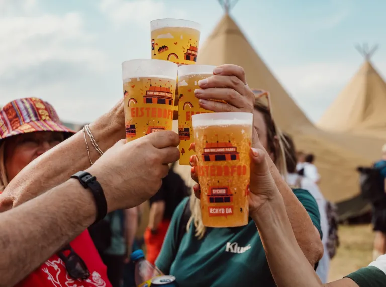 people tapping their Eisteddfod glasses together.