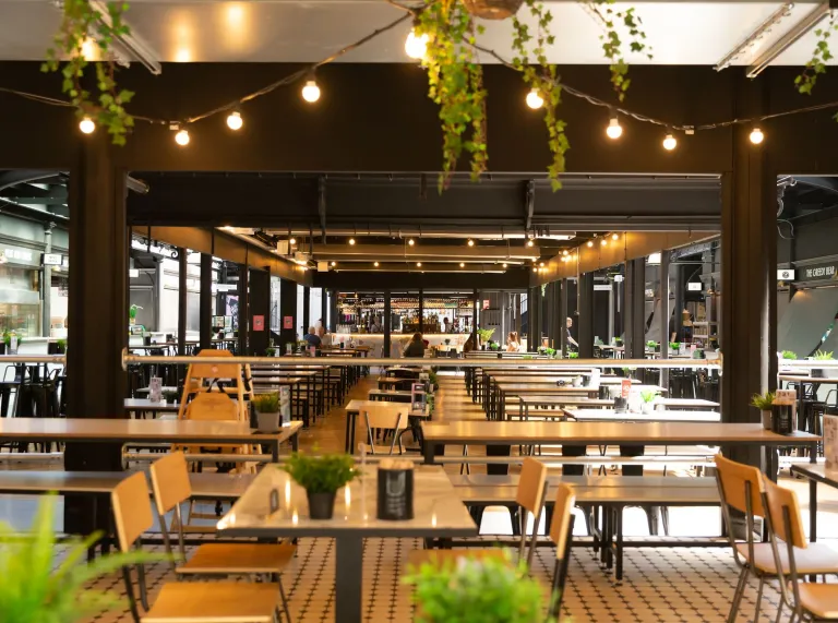 dining tables with plants in market.