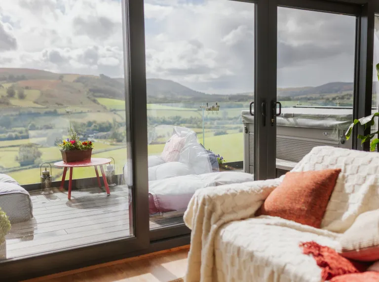 lounge with glass doors and patio, with countryside views. 