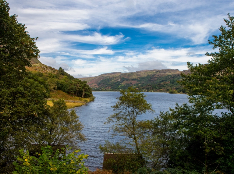 Looking over a lake nestled in wooded hills.