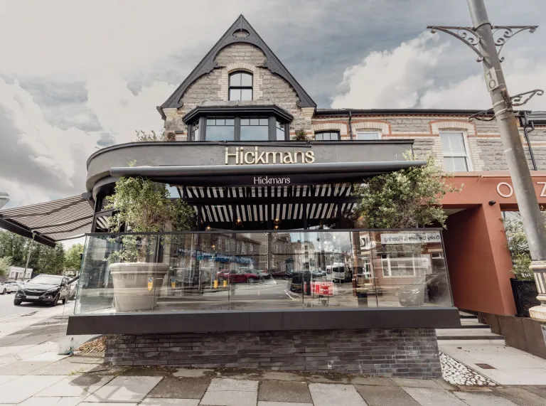 Front exterior of Hickmans restaurant in Penarth with outdoor terrace seating.