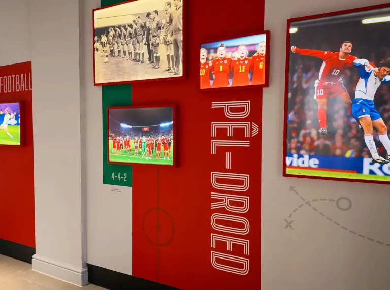 Football Museum of Wales display featuring photographs of Welsh football teams and players across different eras.