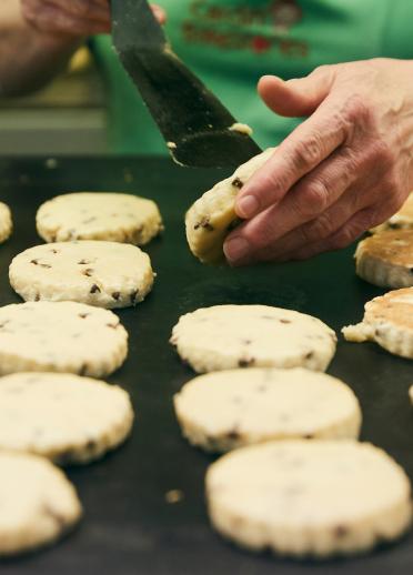 Welshcakes being cooked on a bakestone