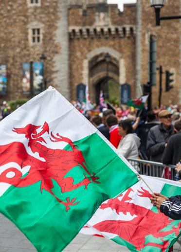 Welsh flags being waved outside Cardiff Castle.