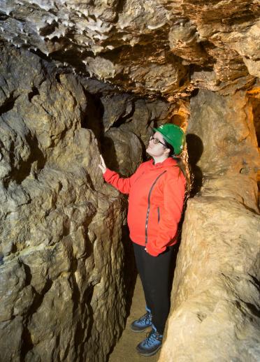 A woman in a tunnel in Great Orme Mines.
