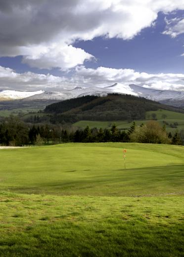 Dramatic mountains seen from one of the greens at Cradoc Golf Club.