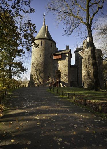 A view of Castell Coch from the path cast in shadows.